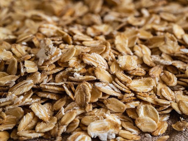 Rolled oats in a wooden spoon - whole grain for weight loss breakfast