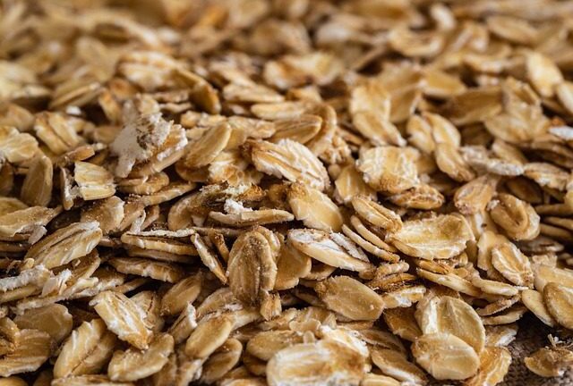 Rolled oats in a wooden spoon - whole grain for weight loss breakfast